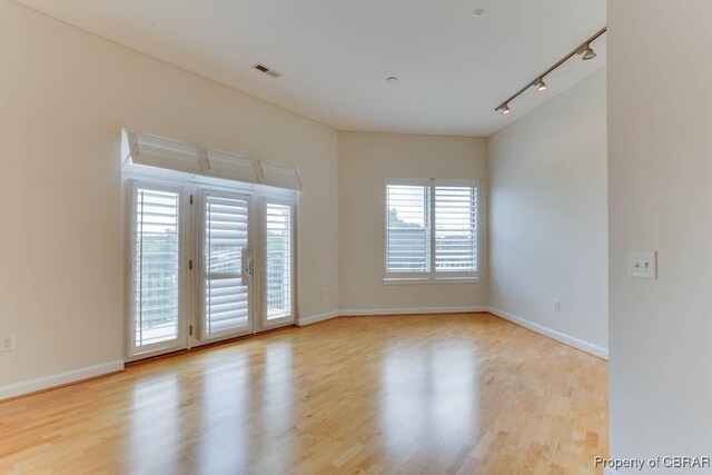 670 Town Center Dr Unit 418, Newport News, VA 23606 - empty room featuring rail lighting, wood finished floors, and baseboards