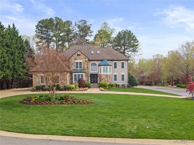 11507 Barrington Bridge Ter, Henrico, VA 23233 - view of front facade featuring stone siding, curved driveway, a front yard, and french doors