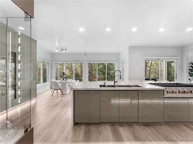 11507 Barrington Bridge Ter, Henrico, VA 23233 - kitchen with stainless steel gas cooktop, healthy amount of natural light, recessed lighting, light wood finished floors, and modern cabinets
