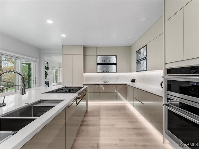 11507 Barrington Bridge Ter, Henrico, VA 23233 - kitchen with modern cabinets, stainless steel appliances, light wood-type flooring, recessed lighting, and decorative backsplash
