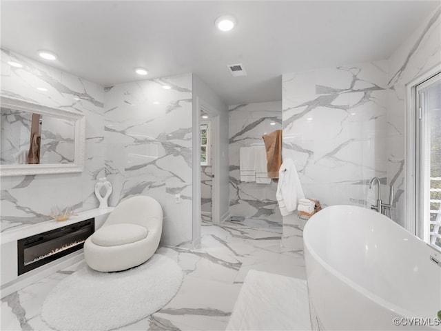 11507 Barrington Bridge Ter, Henrico, VA 23233 - full bath with stone wall, a freestanding bath, recessed lighting, marble tiled flooring, and plenty of natural light