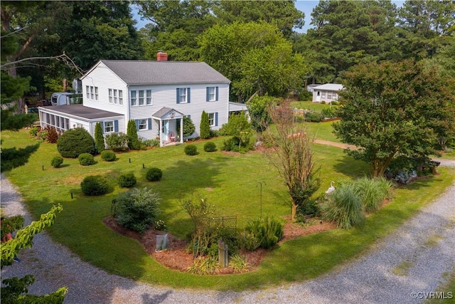 82 Sturgeon St, Deltaville, VA 23043 - colonial home with a chimney, driveway, and a front yard