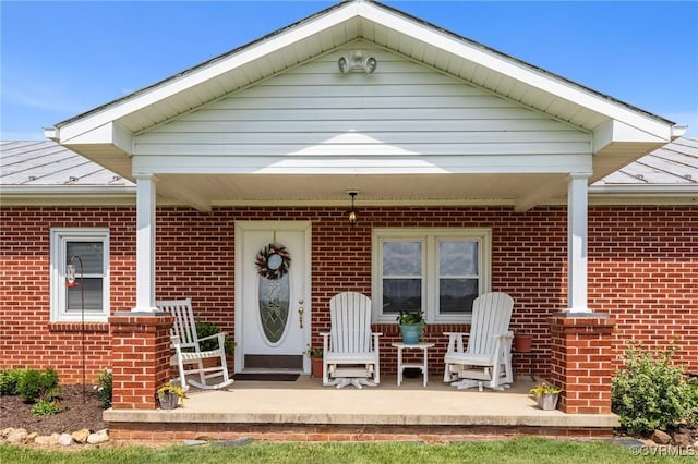 725 Transco Rd, Scottsville, VA 24590 - property entrance featuring brick siding, a standing seam roof, metal roof, and a patio