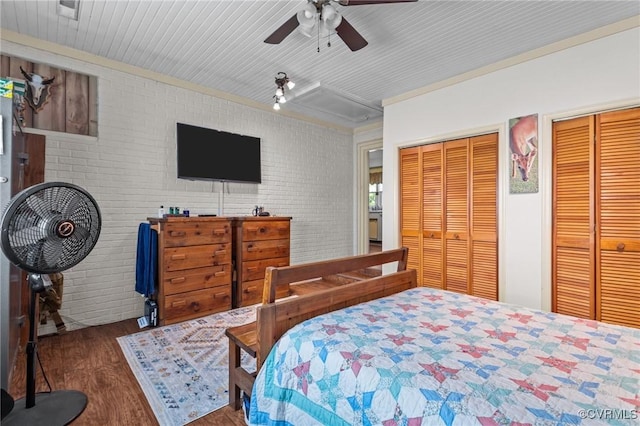 725 Transco Rd, Scottsville, VA 24590 - bedroom featuring multiple closets, wood finished floors, brick wall, ornamental molding, and a ceiling fan