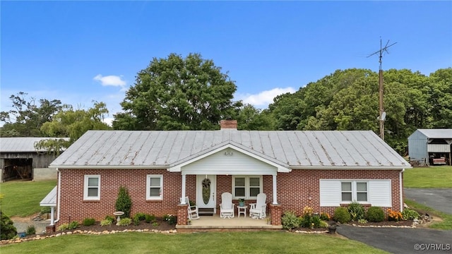 725 Transco Rd, Scottsville, VA 24590 - ranch-style house with brick siding, a standing seam roof, and a front yard