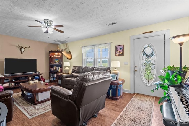 725 Transco Rd, Scottsville, VA 24590 - living room featuring a textured ceiling, a ceiling fan, and wood finished floors