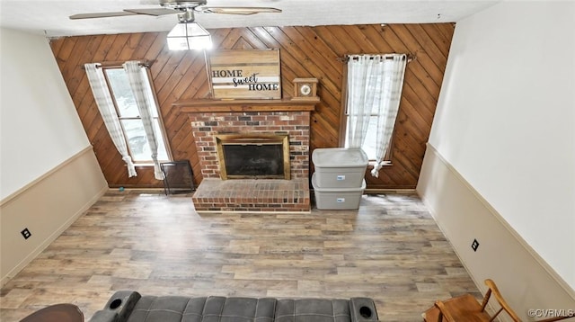 3913 Terjo Ln, Chester, VA 23831 - living area featuring a ceiling fan, wood walls, wood finished floors, and a fireplace