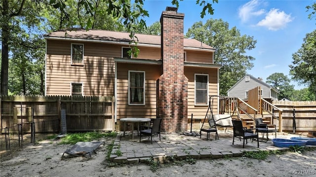 3913 Terjo Ln, Chester, VA 23831 - back of house with a fenced backyard, a patio area, and a chimney