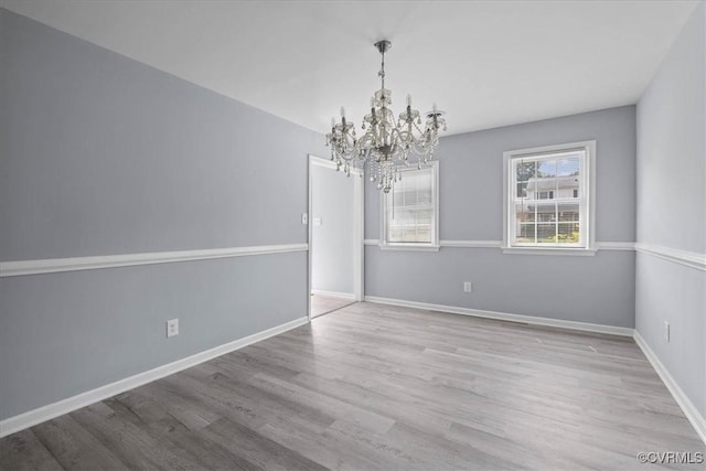 807 N Ave, Hopewell, VA 23860 - unfurnished room featuring a chandelier, wood finished floors, and baseboards