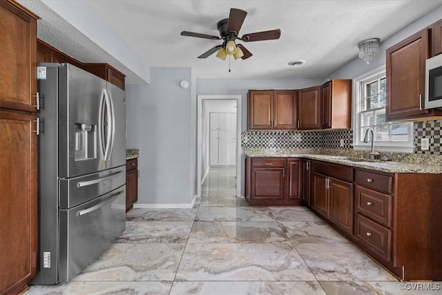 807 N Ave, Hopewell, VA 23860 - kitchen featuring stainless steel appliances, a sink, backsplash, light marble finish flooring, and a textured ceiling