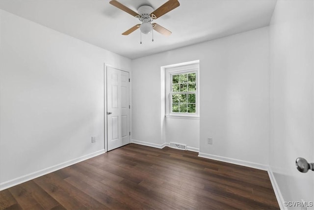 807 N Ave, Hopewell, VA 23860 - empty room with a ceiling fan, dark wood-type flooring, and baseboards