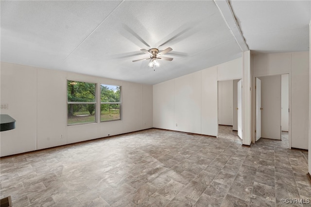 1426 Rolling Acres Rd, Emporia, VA 23847 - empty room featuring a ceiling fan, vaulted ceiling, and stone finish floors