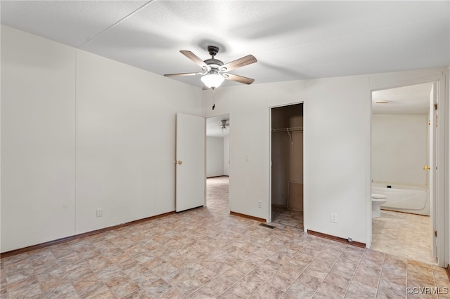1426 Rolling Acres Rd, Emporia, VA 23847 - unfurnished bedroom featuring connected bathroom, a closet, a spacious closet, and ceiling fan