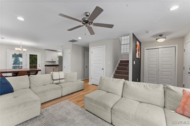 3821 Meridian Ave, Richmond, VA 23234 - living room featuring a chandelier, stairs, healthy amount of natural light, light wood-type flooring, and recessed lighting