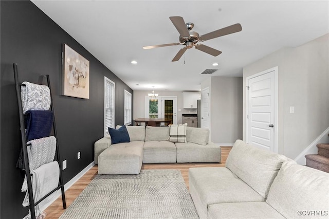 3821 Meridian Ave, Richmond, VA 23234 - living room featuring a chandelier, light wood-style flooring, recessed lighting, ceiling fan, and stairway