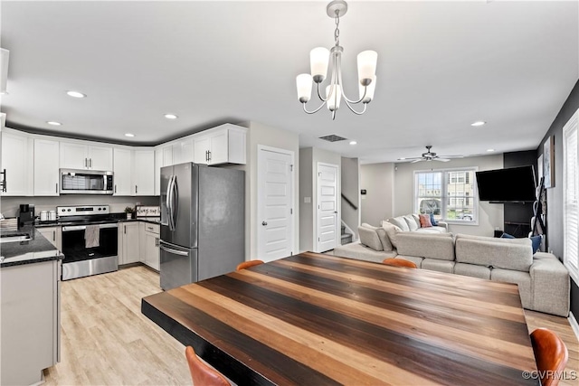 3821 Meridian Ave, Richmond, VA 23234 - dining area featuring stairs, a chandelier, light wood-style floors, recessed lighting, and a ceiling fan