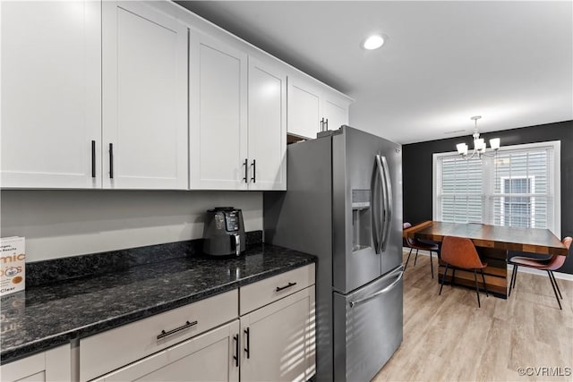 3821 Meridian Ave, Richmond, VA 23234 - kitchen with stainless steel refrigerator with ice dispenser, a chandelier, white cabinets, light wood-type flooring, and dark stone counters