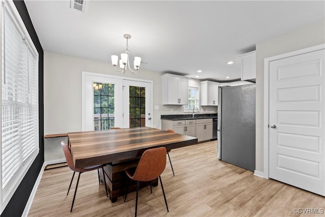 3821 Meridian Ave, Richmond, VA 23234 - dining area with a chandelier, light wood-style floors, recessed lighting, and baseboards