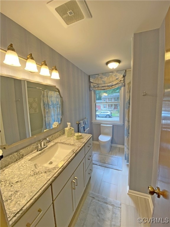1849 Duke Of Gloucester St, Colonial Heights, VA 23834 - bathroom featuring vanity, toilet, baseboards, and curtained shower