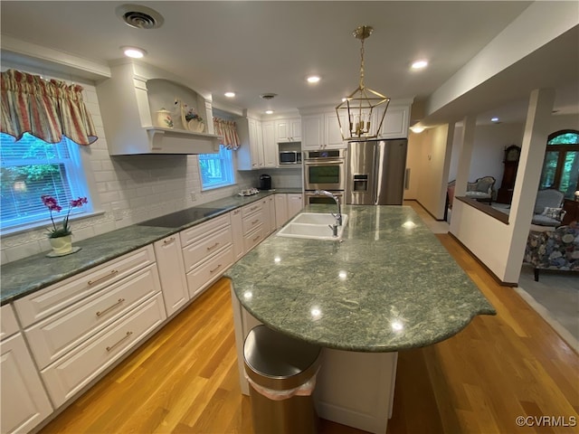 1849 Duke Of Gloucester St, Colonial Heights, VA 23834 - kitchen featuring appliances with stainless steel finishes, a sink, light wood-style flooring, and open shelves