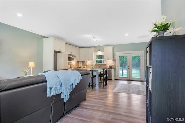 9300 Adkins Rd, Charles City, VA 23030 - living area with wood finished floors, french doors, and recessed lighting