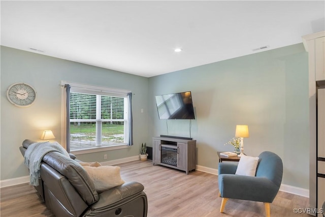 9300 Adkins Rd, Charles City, VA 23030 - living room featuring baseboards, light wood-type flooring, a fireplace, and recessed lighting
