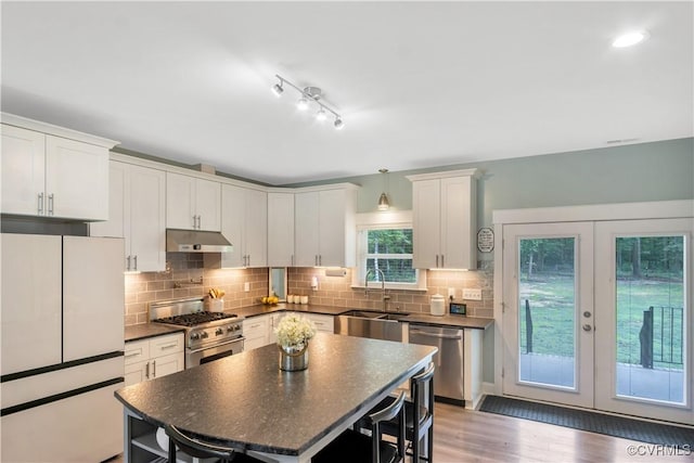 9300 Adkins Rd, Charles City, VA 23030 - kitchen featuring stainless steel appliances, a sink, under cabinet range hood, dark countertops, and french doors