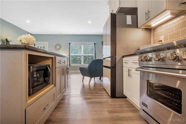 9300 Adkins Rd, Charles City, VA 23030 - kitchen with premium range, light wood finished floors, decorative backsplash, white cabinetry, and recessed lighting