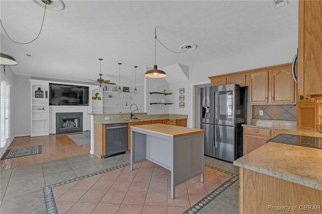 2024 Sarahs Cove Dr, Gloucester, VA 23072 - kitchen featuring stainless steel appliances, ceiling fan, inlaid floor details, and open floor plan