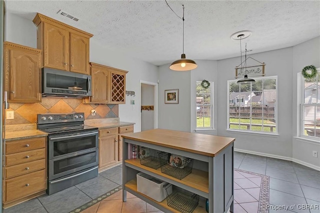 2024 Sarahs Cove Dr, Gloucester, VA 23072 - kitchen with stainless steel appliances, dark tile patterned flooring, backsplash, open shelves, and a kitchen island