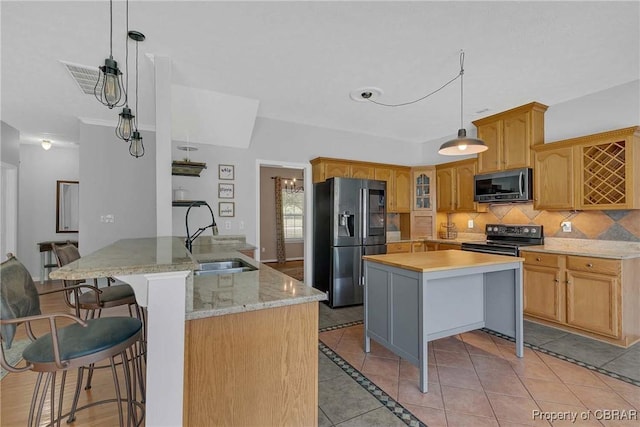 2024 Sarahs Cove Dr, Gloucester, VA 23072 - kitchen featuring black appliances, a kitchen island, decorative backsplash, light tile patterned floors, and a kitchen breakfast bar