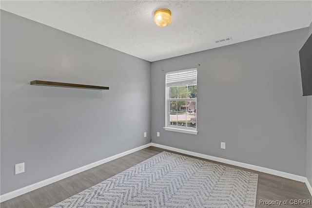 2024 Sarahs Cove Dr, Gloucester, VA 23072 - spare room with wood finished floors and a textured ceiling