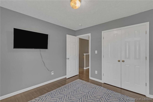 2024 Sarahs Cove Dr, Gloucester, VA 23072 - bedroom featuring wood finished floors, a closet, and a textured ceiling