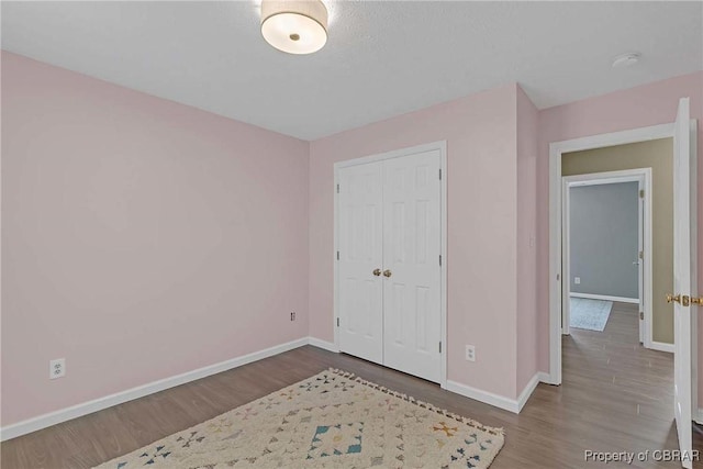 2024 Sarahs Cove Dr, Gloucester, VA 23072 - unfurnished bedroom with wood finished floors and a closet