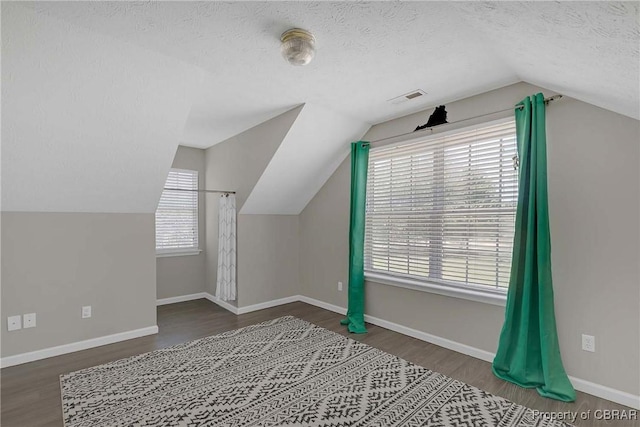 2024 Sarahs Cove Dr, Gloucester, VA 23072 - bonus room featuring vaulted ceiling, wood finished floors, and a textured ceiling