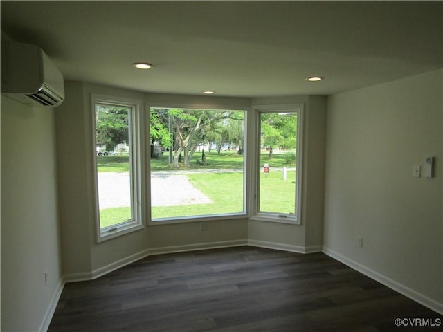 135 Trudie Dr, Center Cross, VA 22437 - unfurnished room with a wall unit AC, plenty of natural light, dark wood-style flooring, and recessed lighting