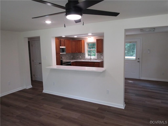135 Trudie Dr, Center Cross, VA 22437 - kitchen with a ceiling fan, electric stove, stainless steel microwave, dark wood finished floors, and light countertops
