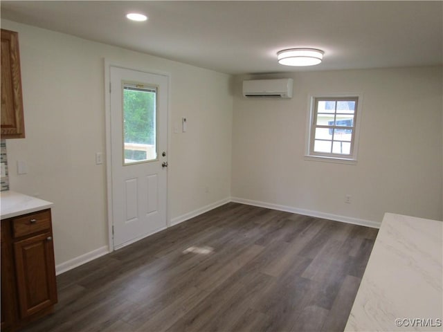 135 Trudie Dr, Center Cross, VA 22437 - unfurnished dining area with an AC wall unit, dark wood-style floors, and recessed lighting
