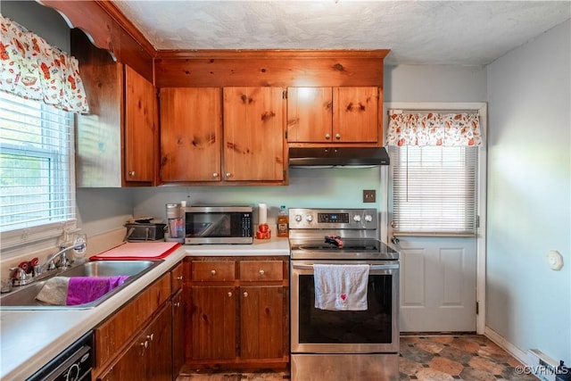 18517 Depot Rd, Mc Kenney, VA 23872 - kitchen featuring appliances with stainless steel finishes, under cabinet range hood, light countertops, and brown cabinetry