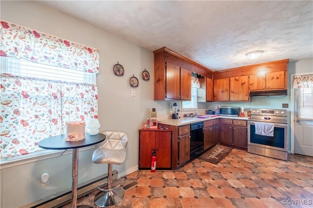18517 Depot Rd, Mc Kenney, VA 23872 - kitchen featuring stainless steel appliances, under cabinet range hood, light countertops, brown cabinetry, and a baseboard heating unit