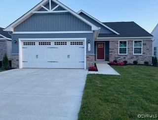 7128 Iron Gall Ln, Ruther Glen, VA 22546 - craftsman-style home with stone siding, a garage, driveway, a front yard, and board and batten siding