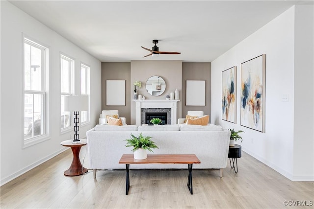16300 Cambian Ln, Chesterfield, VA 23832 - living room featuring a ceiling fan, light wood-style flooring, a fireplace, and baseboards