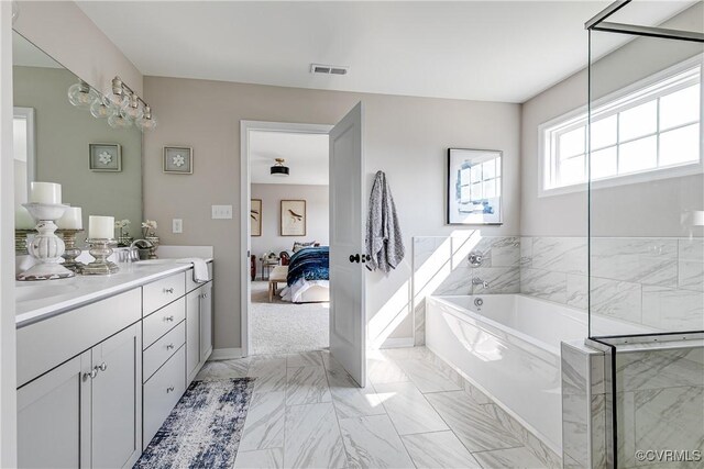 16300 Cambian Ln, Chesterfield, VA 23832 - ensuite bathroom with vanity, a bath, marble finish flooring, and baseboards