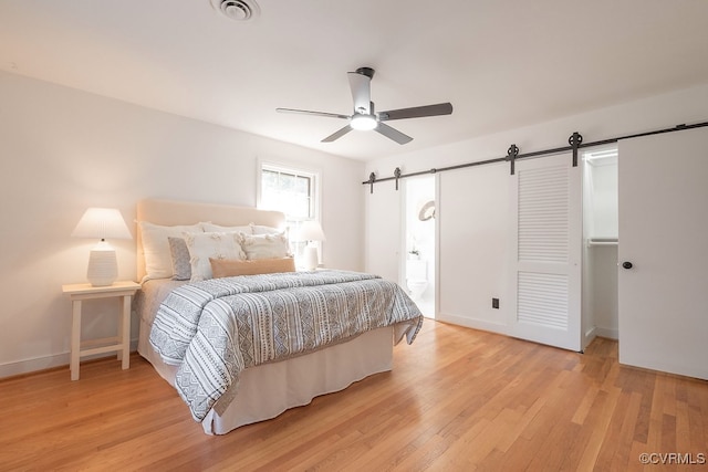 5055 Edgemere Blvd, North Chesterfield, VA 23234 - bedroom with a barn door, light wood finished floors, baseboards, and ceiling fan
