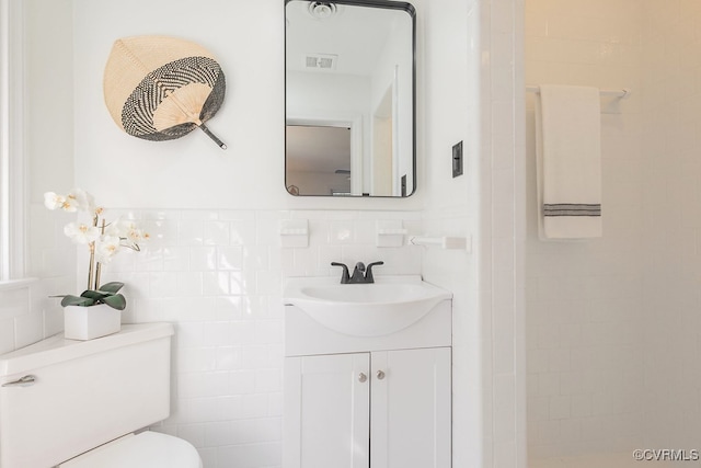 5055 Edgemere Blvd, North Chesterfield, VA 23234 - bathroom with vanity, tile walls, toilet, and backsplash