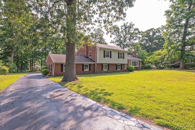 5055 Edgemere Blvd, North Chesterfield, VA 23234 - view of front of property with a chimney, brick siding, and a front yard