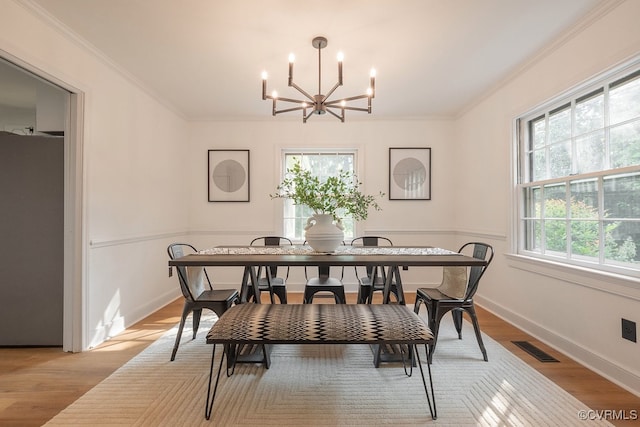 5055 Edgemere Blvd, North Chesterfield, VA 23234 - dining area featuring a chandelier, crown molding, light wood finished floors, and baseboards
