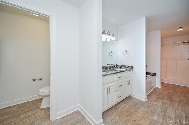 1037 Berryhill Rd, Henrico, VA 23231 - bathroom with double vanity, wood finished floors, and a bath