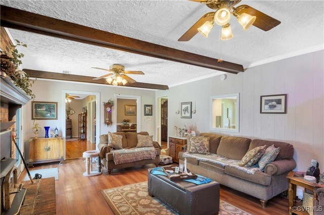 1468 Peppercorn Ln, Suffolk, VA 23432 - living room featuring a ceiling fan, a textured ceiling, wood finished floors, and beam ceiling