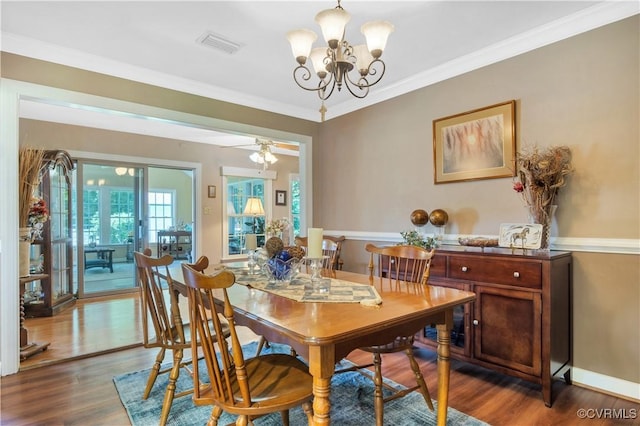 1468 Peppercorn Ln, Suffolk, VA 23432 - dining area featuring wood finished floors, a chandelier, and ornamental molding